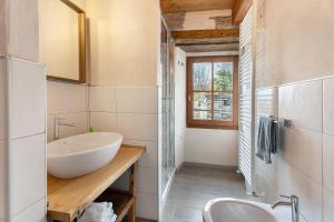 a bathroom with a white sink and a mirror at La torretta di Mozzola in Oggebio +36 photos
