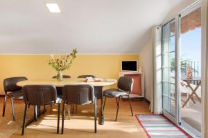 a dining room with a table and chairs at Casa Amarela in Caniço
