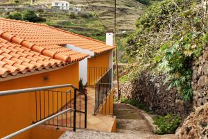 a staircase leading to a yellow house on a hill at Casa Amarela in Caniço