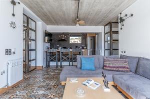 a living room with a couch and a table at A The Country House in Tinos +22 photos