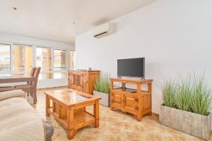 a living room with a couch and a tv at Apto Urb Centro Internacional A117 in Torrox