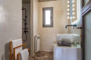 a bathroom with a sink and a shower at A The Country House in Tinos
