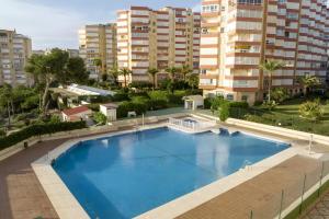 an overhead view of a large swimming pool with buildings in the background at Apto Urb Centro Internacional A117 in Torrox