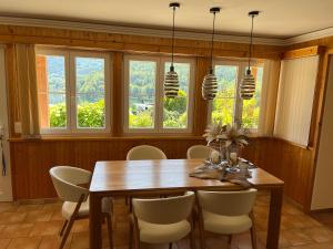 a dining room with a table and chairs and windows at Seerhaus in Mosern