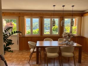 a dining room with a table and chairs and windows at Seerhaus in Mosern