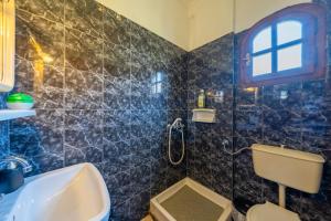 a bathroom with a sink and a toilet and a window at Nana's House Holidays Greece in Dragotiná +23 photos