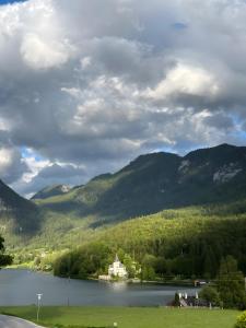 a house on a lake with mountains in the background at Seerhaus in Mosern +2 photos