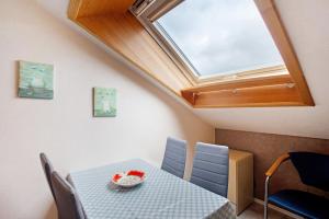 a dining room with a table and a skylight at Ferienwohnung Triska in Balve