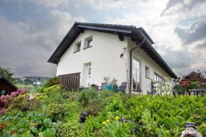 a white house with a black roof at Ferienwohnung Triska in Balve