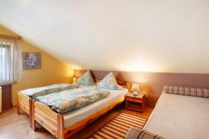 a bedroom with a bed and a couch and a window at Ferienwohnung Triska in Balve