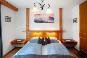 a bedroom with a bed with blue comforter at Ferienhaus Werdenfels in Mittenwald