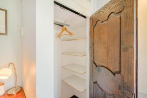 a closet with a wooden door and shelves at Le Grimaldi in Cagnes-sur-Mer +123 photos