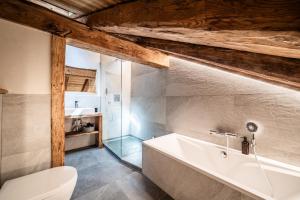 a bathroom with a bath tub and a toilet at Le Perray Alpine Lodge in Abondance +37 photos