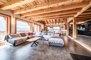 a large living room with a couch and a table at Le Perray Alpine Lodge in Abondance