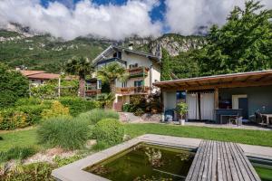 a house with a pond in the yard at Kraidlhof Designapartment Veronika in Cortaccia