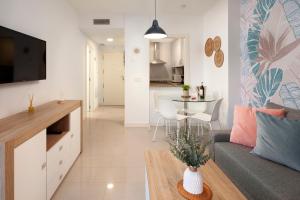 a living room with a couch and a table at Playamarinsa in Torre del Mar