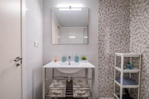 a bathroom with a sink and a mirror at Playamarinsa in Torre del Mar +19 photos