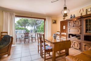 a living room with a wooden table and a dining room at Casa Isabel in Calonge
