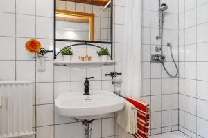 a white bathroom with a sink and a shower at Ferienwohnung Zapf in Forbach +17 photos