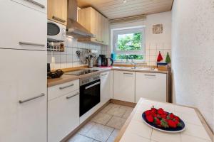 a kitchen with a bowl of fruit on a table at Ferienwohnung Zapf in Forbach