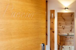 a wooden door with the word nooni written on it at Villa Solinda App Puccini in Selva di Val Gardena