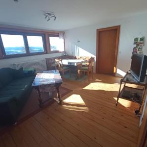 a living room with a couch and a table at Haus Fehrenbach in Sankt Märgen