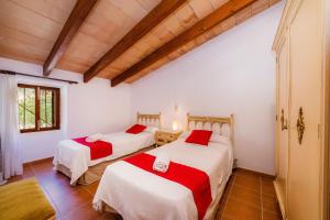a bedroom with two beds in a room at Finca Ses Coves in Petra