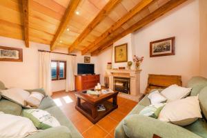 a living room with two couches and a fireplace at Finca Ses Coves in Petra