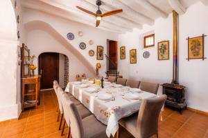 a dining room with a long table and chairs at Finca Ses Coves in Petra