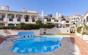 a swimming pool in front of a building at Verano Azul in Nerja