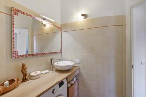 a bathroom with a sink and a mirror at Villa sole e mare in Cipressa +43 photos