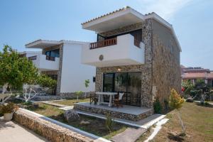 a house with a table in front of it at Mirage Arillas Studio Type A5 in Arillas