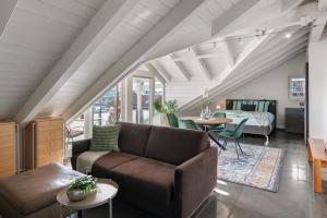 a living room with a couch and a bed at Dachgeschosswohnung in Hofolding in Brunnthal