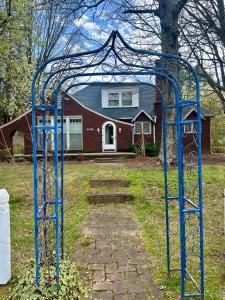 a blue metal structure in front of a house at Town Square Charm Century Old in Lewisville +5 photos