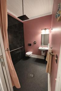 a bathroom with a toilet and a sink at Town Square Charm Century Old in Lewisville