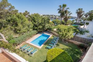 an aerial view of a swimming pool with lounge chairs and trees at Villa Es Cantò in Cacla D'or