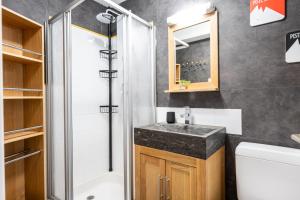 a bathroom with a sink and a shower at victorsun2 in La Clusaz +16 photos