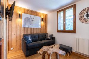 a living room with a couch and a table at victorsun2 in La Clusaz