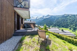 a house with a balcony with a view of mountains at victorsun2 in La Clusaz
