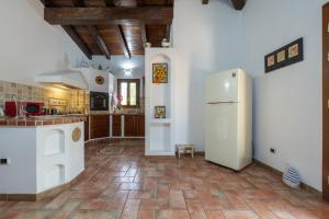 a kitchen with a white refrigerator in a room at Villa Rossu in Nuxis +21 photos
