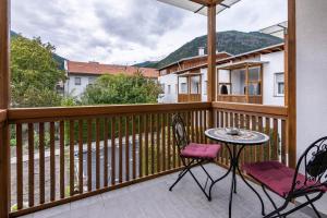 a patio with a table and chairs on a balcony at Ferienwohnung Hans in Prato allo Stelvio