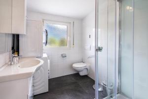 a bathroom with a toilet and a sink and a shower at Ferienwohnung Hans in Prato allo Stelvio +18 photos