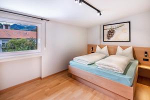 a bedroom with a bed and a window at Ferienwohnung Hans in Prato allo Stelvio