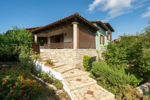 a house with a stone staircase leading to a yard at Villa Rossu in Nuxis
