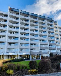 a large white apartment building with balconies at 307 im Lord Nelson in Cuxhaven