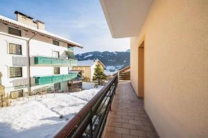 a balcony of a building with snow on the ground at Appartamento Cornon in Tesero