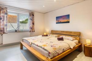 a bedroom with a large bed and a window at Ferienwohnung Landblick in Homberg