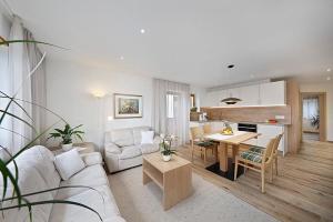 a living room with a white couch and a table at Wieser in Schenna