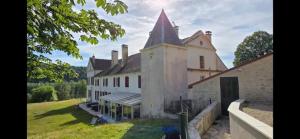a large white building with a tower on top of it at Domaine du Val Bruant in Arc-en-Barrois +8 photos