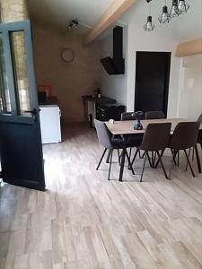 a dining room with a table and chairs in a room at Domaine du Val Bruant in Arc-en-Barrois